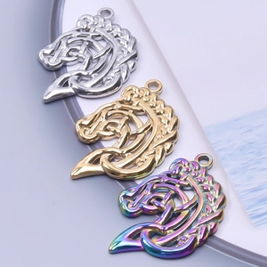 Macro view of Celtic horse head pendants in silver, gold, and rainbow metallic finishes