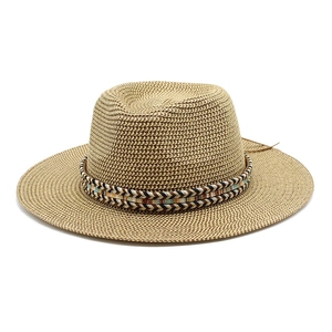 Detail of hand-woven straw hat featuring a multi-colored ethnic style patterned ribbon band