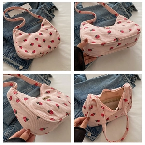 Detail view of pink corduroy strawberry shoulder bag with gold hardware and interior layout