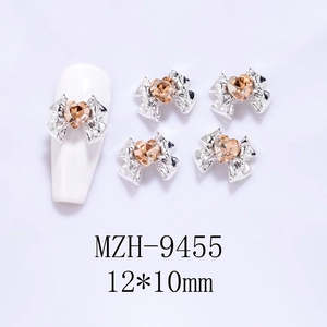 Detail of 12x10mm bow nail art charm with amber heart crystal and silver metal base