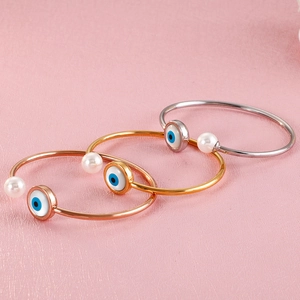 Three-color Evil Eye and pearl open bangle bracelets in gold, silver, and rose gold