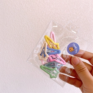 Star-shaped colorful metal hair clips for girls packed in a clear bag with a thank you sticker