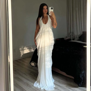 Detail of white halter neck maxi dress with pleated texture and backless design