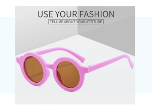 Detail view of pink round frame kids sunglasses with protective dark brown UV400 lenses