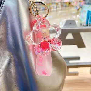 Pink sakura floating liquid keychain with bear figurine on silver handbag handle