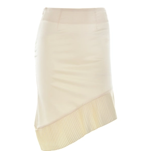 Detail view of the beige skirt showing the asymmetric pleated hem and side invisible zipper