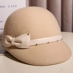 Elegant wool felt equestrian hat with leather bow and metal studs in camel brown