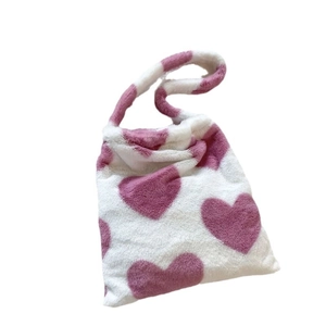 White plush tote bag with pink heart pattern and soft faux fur shoulder strap