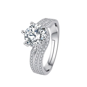 Close-up of six-prong solitaire ring with spiral pavé band and adjustable opening