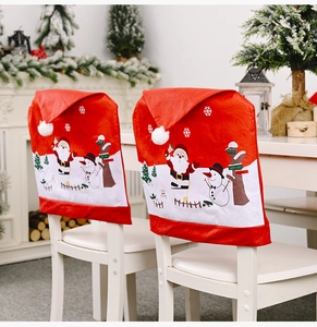 Detail of Christmas chair covers featuring Santa and Snowman prints in a cozy home setting
