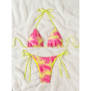 Flat lay of pink and yellow tie-dye bikini set with adjustable side ties and halter top