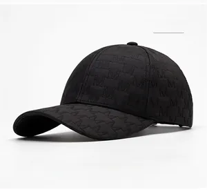 Detail of black baseball cap with 3D embossed M letter texture and curved brim