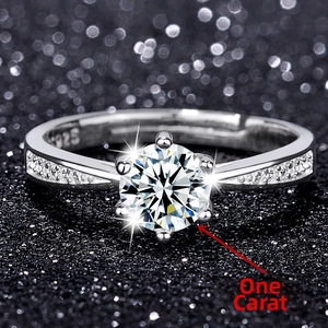 Macro shot of S925 sterling silver ring with 1 carat six-prong moissanite and engraving