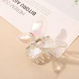Detail of butterfly hair claw with iridescent aurora finish and metal spring mechanism