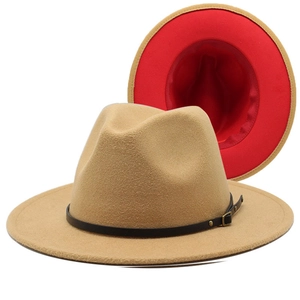 Detail of khaki fedora hat featuring a bold red lining and black leather decorative belt