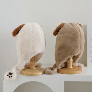 Detail of plush cartoon puppy hats with cute 3D ears and paw print ear flaps in soft beige