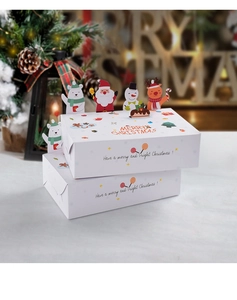 Close-up of 3D Christmas gift boxes with cartoon Santa and snowman against bokeh tree