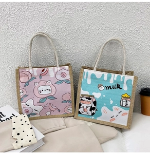 Detail of jute canvas tote bags with cute peach and milk cow prints and rope handles