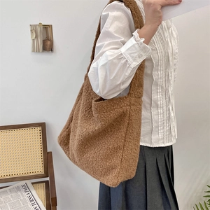 Detailed close-up of the plush wool texture and spacious design of this brown tote bag