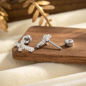 Gothic punk silver cross stud earrings with textured pattern and screw back closure