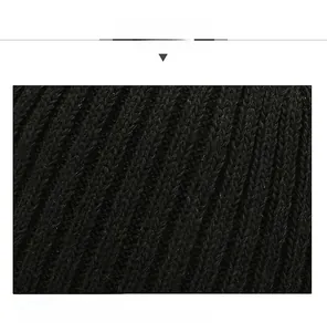 Close-up of black ribbed knit fabric showing the dense texture and soft wool material