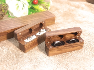 Detail of walnut wood double ring box showing magnetic closure and velvet interior