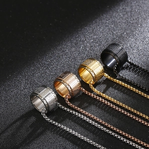 Detail of four stainless steel mantra rings in silver gold rose gold and black finishes