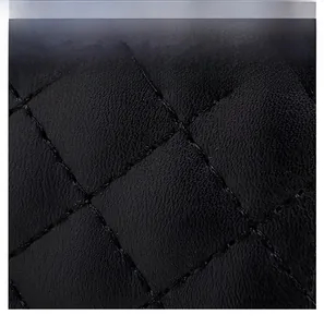 Detailed close-up of high-quality black quilted leather with fine diamond stitching pattern