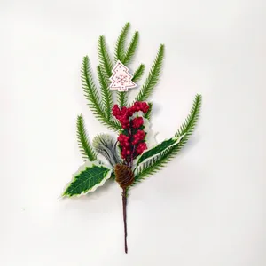 Detail of Christmas sprig with pine needles, red berries, pinecone and wood tree tag