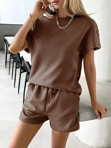 Detailed close-up of dark brown knit fabric texture on summer top and shorts set