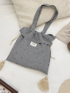 Checkered canvas tote bag with ruffled edges and long fringe tassels for daily casual use