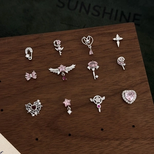Detailed collection of pink zircon heart and star stud earrings on a wooden display