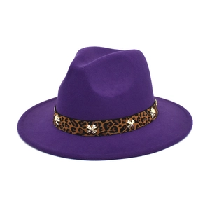 Detailed texture of purple wool fedora hat featuring leopard band with gold star studs
