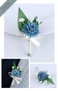 Detail of dusty blue wedding boutonniere with silk petals and golden edge ribbon