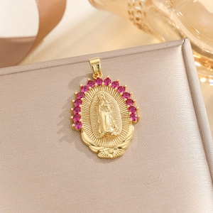Macro detail of gold Virgin Mary pendant with radial rays and pink zircon stones