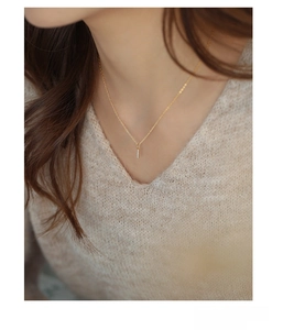 Close-up of S925 sterling silver bar necklace with pavé diamonds on a model neck