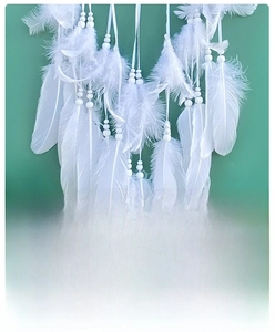 Detailed macro view of high quality white feathers with round beads for dreamcatcher decor