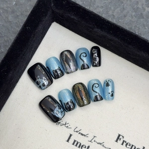 Handmade cat eye press-on nails set featuring blue cat patterns and glitter finishes