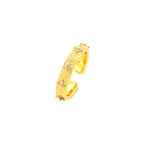 Detail of vintage gold brushed texture ring with floral zircon inlay in a macro view