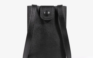 Close-up of black lychee grain leather mini phone bag with round snap button closure