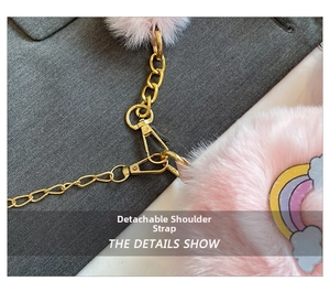 Close-up of pink plush heart bag featuring a removable gold chain strap and cute patches