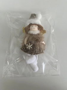Detail of plush Christmas angel ornament with golden wings and checkered skirt