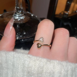 Detailed close-up of 18k gold-plated double heart open ring with cubic zirconia inlay