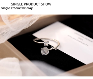 Macro detail of S925 silver camellia flower ring with sparkling zircon and open band