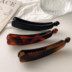 Three matte banana hair clips in black, leopard, and amber for thin or thick hair styling
