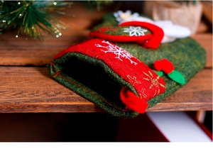 Detail of rustic Christmas stocking with embroidered snowflake and plush white trim decor