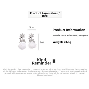 Detail view of plush Christmas earrings with rhinestones, snowflake and reindeer charms