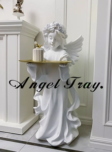 Detailed view of white angel resin statue holding a functional golden serving tray