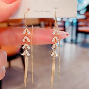 Elegant gold tassel earrings with leaf-shaped zircon crystals and long metallic chains