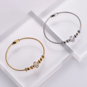 Gold and silver stainless steel wire bangles with sparkling clover charms for women